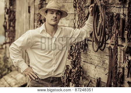 Farmer Portrait In Front Of A Wall Full Of Tools