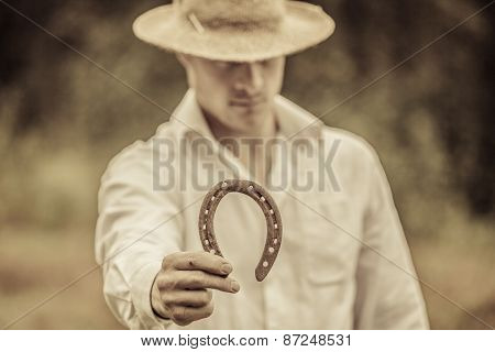 Lucky Farmer Holding A Horseshoe