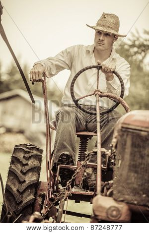 Young Farmer On A Vintage Tractor
