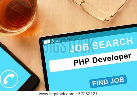 Tablet with PHP Developer on job search site.