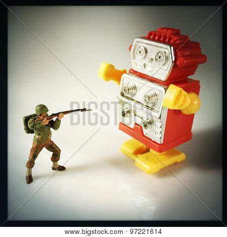 Vintage style Toy Soldier shooting at robot with an Instagram style filter