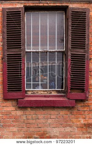 Window With Worn Out Wooden Shutters