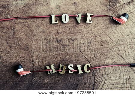Portable Audio Earphones On Old Wood Textured With Word 