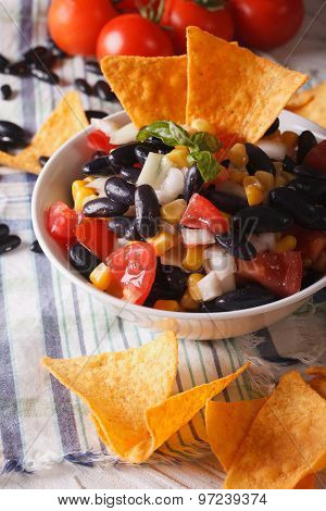 Mexican Food: Salsa With Black Beans And Nachos Closeup. Vertical