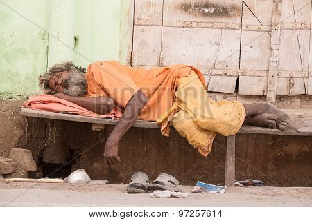 Indian Homeless Man Sleeps  Near The Ghat Along The Sacred Sarovar Lake
