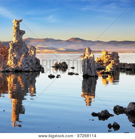   Yosemite National Park, USA. Outliers -  bizarre calcareous tufa formation  reflected in the mirrored surface of the water. The picturesque sunset at Mono Lake