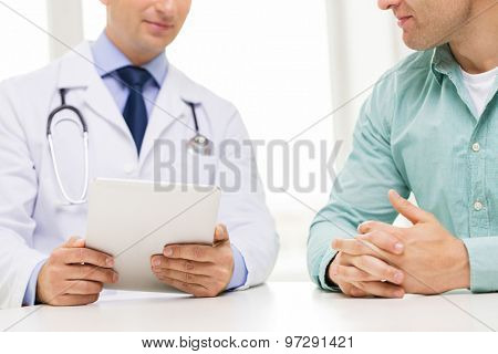 medicine, health care, people and technology concept - close up of f male doctor and patient hands with tablet pc computer