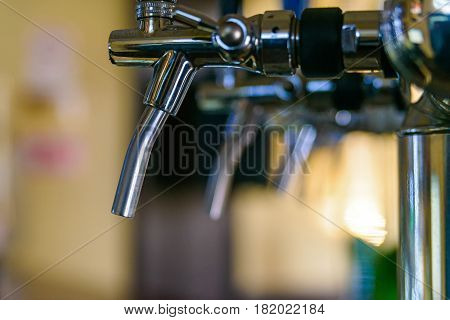 Close-up of modern beer taps in pub