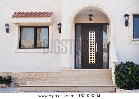 A front entrance of a home with a door.