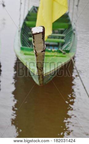 prow of long tail motor boat mooring at pier