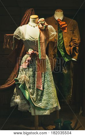 Austrian national folk costumes or garment for men and women. Traditional Tracht. Feminine dress Dirndl and men' s Lederhosen short breeches made of leather, and suit jacket