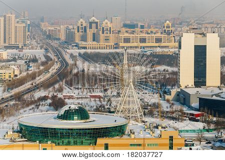 Mega Center Astana and the Ferris wheel on the left bank of Astana, Kazakhstan.