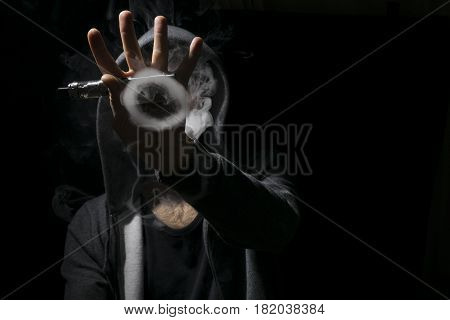 Circle Tricks Of Smoke Vaping By A Young Man.
