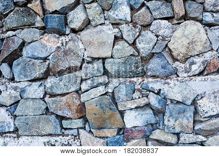 Background wall made of stone. Fragment of a wall from a chipped stone