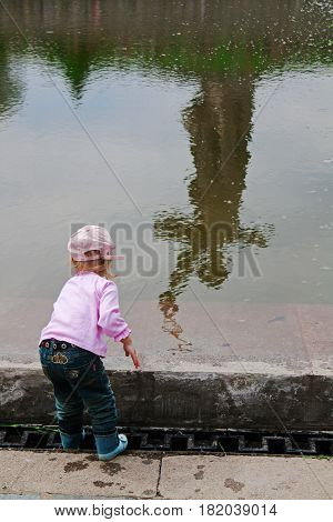 Volgograd Russia - May 9 2010: Little girl on the background of reflection of monument 