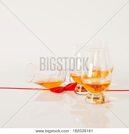 Set Of Single Malt Tasting Glasses, Single Malt Whisky In A Glasses, White Background, Red Bow