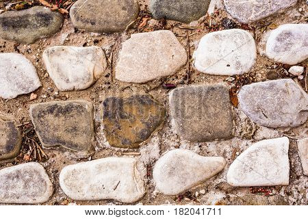 Background wall made of stone. Fragment of a wall from a chipped stone