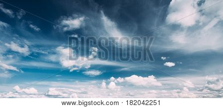 Panorama Of Bright Blue Sky With White Fluffy Clouds. Cloudy Sky. Blue Sunny Cloudscape Background