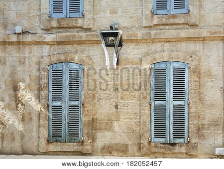 The facade of an old apartment building in the historic center of Avignon in France