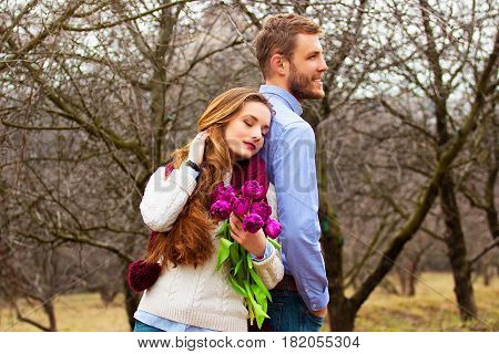 Romantic Love Story. Portrait Of Beautiful Young Couple In Casual Clothes Back To Back Together With