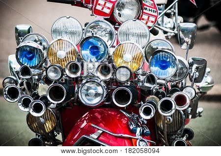 red scooter with an array of headlamps