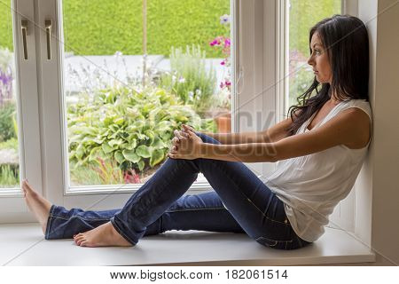 woman sitting on window