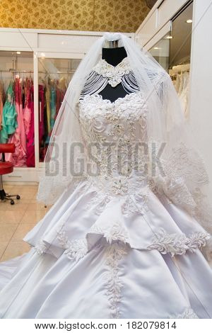 white wedding dress gown on mannequin in bridal gown. Bride's morning wedding preparation concept