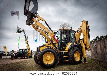 RIGA, LATVIA - APRIL 2017: Cat tractors and other construction equipment at the public event of Riga Machinery Sales.