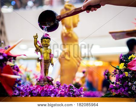 Siddhartha Gautama Buddha Sculpture Flushed by Water and Flower