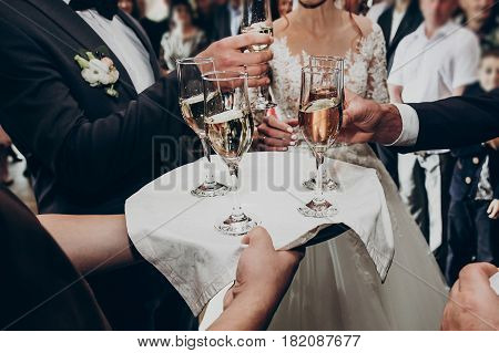 Glasses Of Champagne On Tray, Hands Holding Glasses And Toasting, Celebrating Wedding. Stylish Happy
