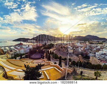Cartagena, Spain. Aerial view of port city Cartagena in Spain with famous roman amphitheater. Beautiful sunset over the mountains.