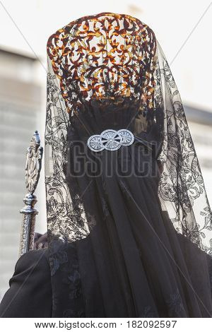 Woman dressed in mantilla during a procession of holy week Spain