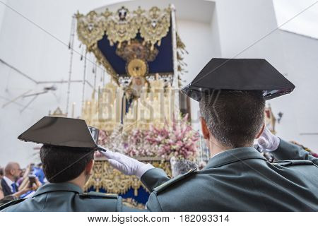 Linares SPAIN - April 16: Soldiers of the Spanish civil guard salute when the national anthem at the exit of the Virgin of beautiful love during Holy week in Linares Andalusia Spain