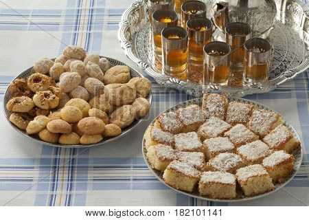 Traditional variety of festive Moroccan cookies and mint tea