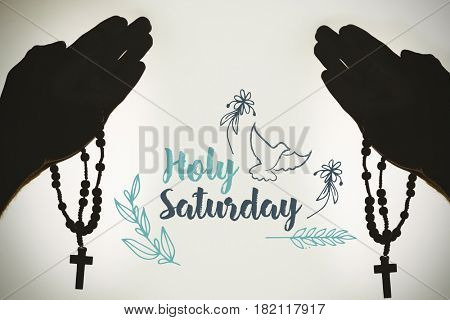 Easter message against solhouette hand with rosary praying