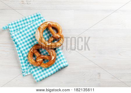 Pretzel. Beer snacks on wooden table. Top view with copy space