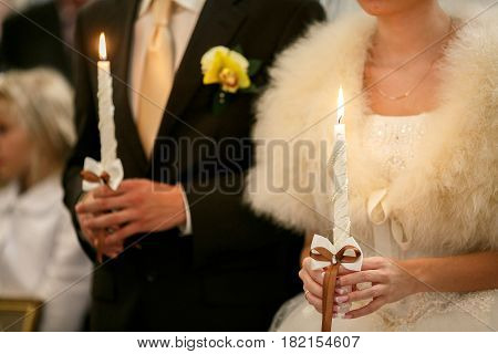 Burning candles helb by newlyweds during the ceremony