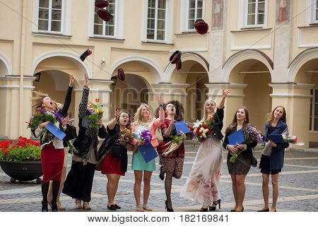 Vilnius Lithuania - June 18 2014: Students of Vilnius University are throwing their head-wear during student graduation ceremony in the courtyard of the university.