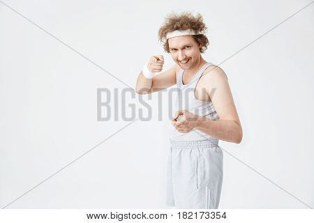 Retro man pointing at camera with pointer fingers. Motivated funny sportsman ready for training hard