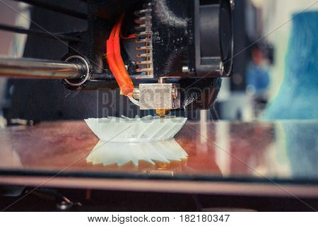 3D printer working and creating an object from the hot molten plastic close-up. Automatic three dimensional 3d printer performs plastic.