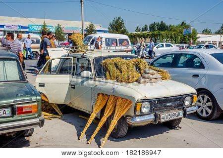 MARGILAN UZBEKISTAN - AUGUST 21: Old Lada car with brooms for sale at Kumtepa bazaar. Market in one the the biggest in the area running once a week. August 2016