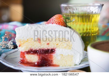 coffee cup and delicious cake strawberry and relax time moblie on table in coffee shop
