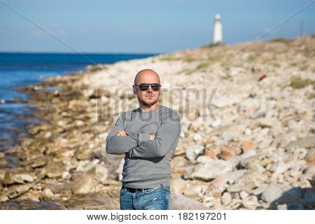 Man on a beach close to lighter beacon looking forward