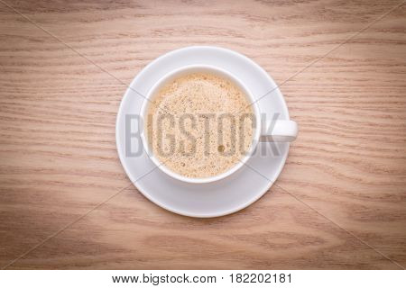 isolated cup of milk coffee on wooden table. Latte
