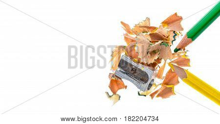 Two Wooden Colour Pencils, Metal Sharpener And Pencil Shavings.