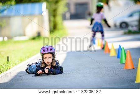 Child Fell While Learning To Roller Skate On The Road.