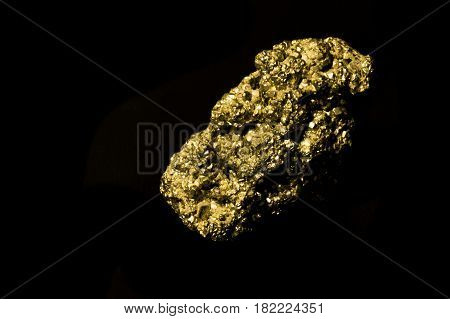 Iron sulphide on black background. Isolated. Similar like gold.