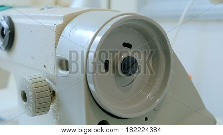 Part of sewing machine at atelier. Fashion and tailoring concept