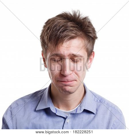 Feeling unhappy. Sad man crying, expressing negative emotion on white isolated studio background
