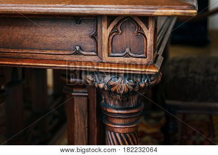 Angle and carved leg of an ancient vintage antique wooden table